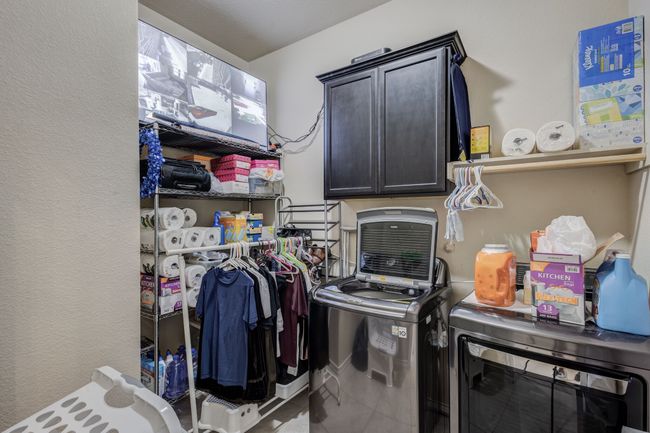 Laundry room with washer and clothes dryer, cabinet space, and tile patterned floors | Image 28