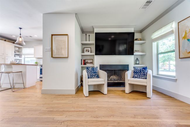 Sitting room with crown molding, baseboards, plenty of natural light, a fireplace, and recessed lighting | Image 6