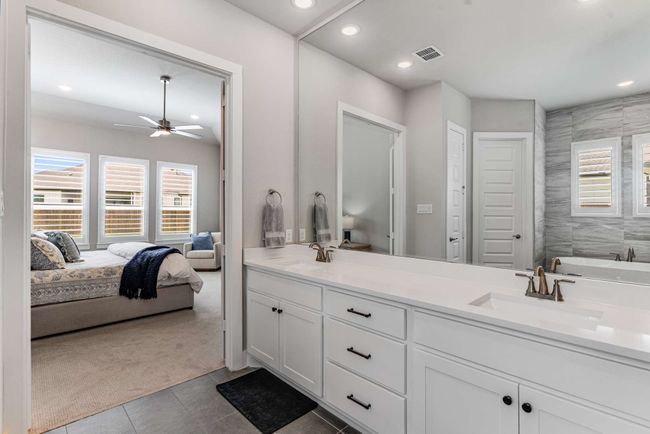 Double sinks with tall vanity in the primary suite. | Image 18