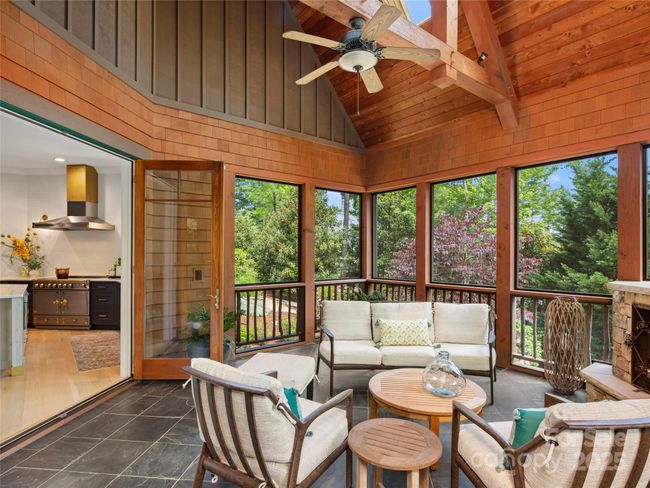 Glass paned French doors provide entry into the screened porch from the kitchen/dining area. | Image 19