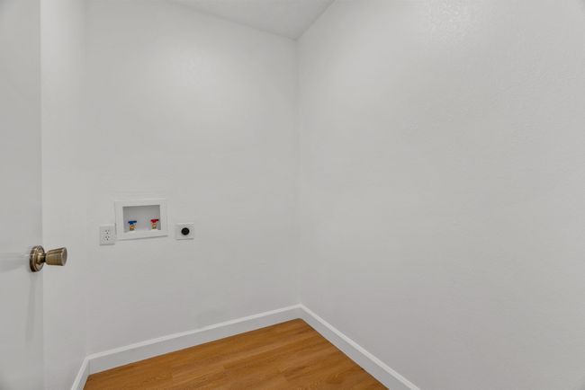 Laundry room featuring electric dryer hookup, washer hookup, and light wood-style flooring | Image 29