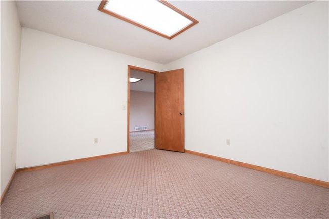 Unfurnished room featuring light colored carpet and baseboards | Image 26