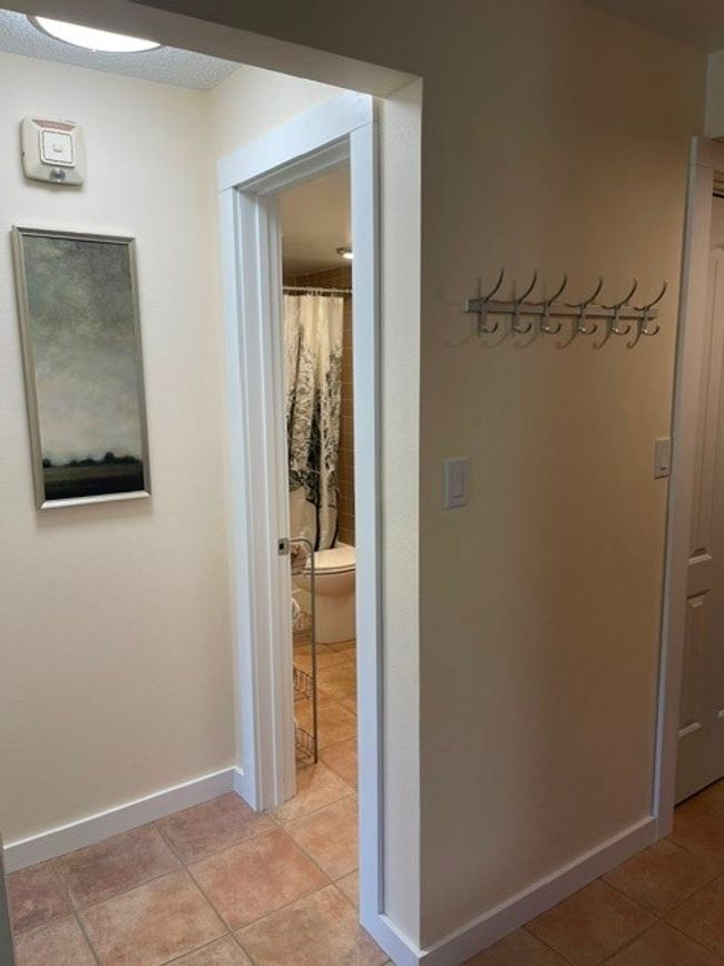 Hall featuring light tile patterned flooring and baseboards | Image 10