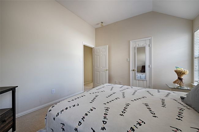 Bedroom featuring carpet, lofted ceiling, and baseboards | Image 15