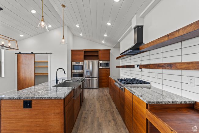 Kitchen featuring open shelves, appliances with stainless steel finishes, modern cabinets, a sink, and recessed lighting | Image 6