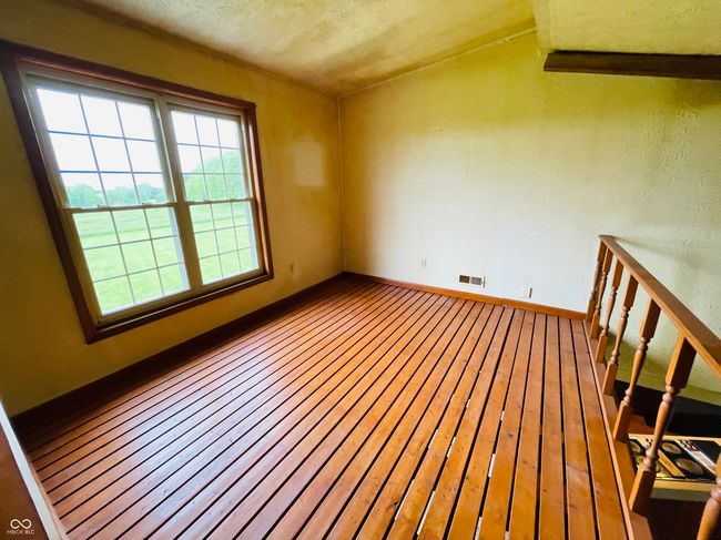 empty room featuring plenty of natural light, baseboards, hardwood / wood-style flooring, and a textured ceiling | Image 24