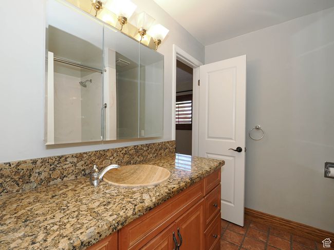 Bathroom with vanity, baseboards, and a shower | Image 22