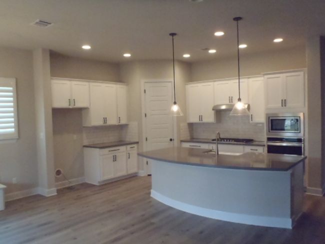 Kitchen with appliances with stainless steel finishes, decorative backsplash, dark wood-type flooring, and recessed lighting | Image 13