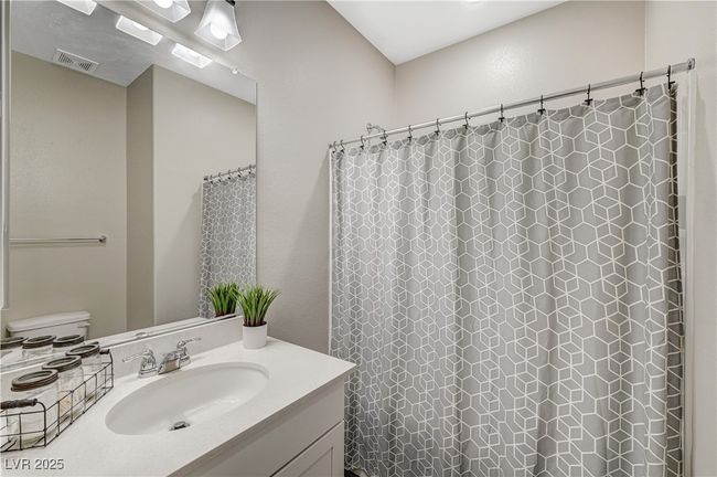 Full bath with vanity, toilet, and curtained shower | Image 31