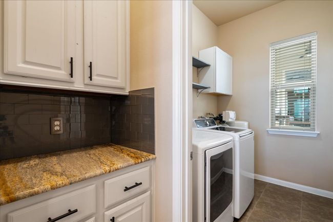 Behind the kitchen there is a coffee bar leading to the tucked away laundry room. | Image 17