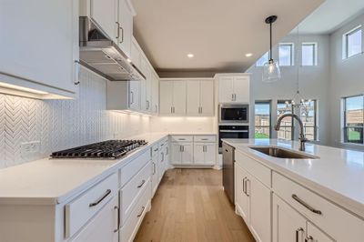 Kitchen with white cabinets, sink, plenty of natural light, and stainless steel appliances | Image 3