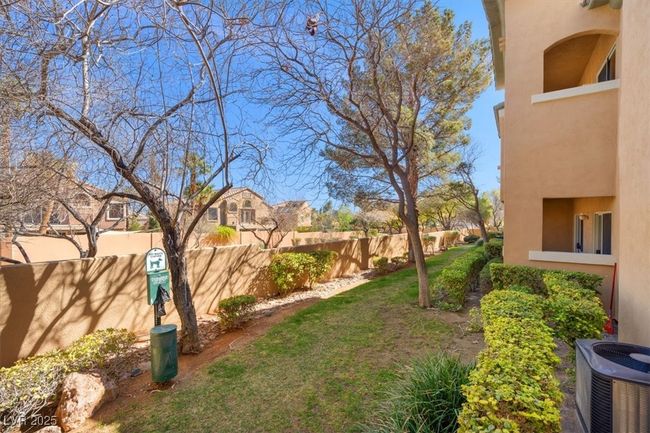 View of yard featuring a residential view, a balcony, central AC, and fence | Image 18