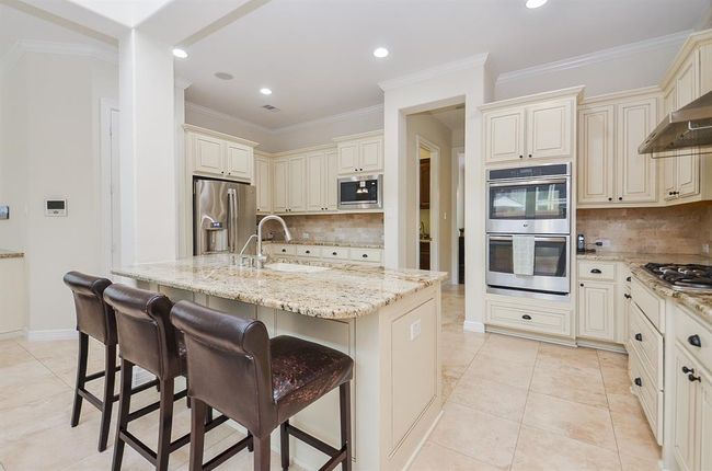 Kitchen with upgraded granite and cabinetry. Refrigerator stays. | Image 13