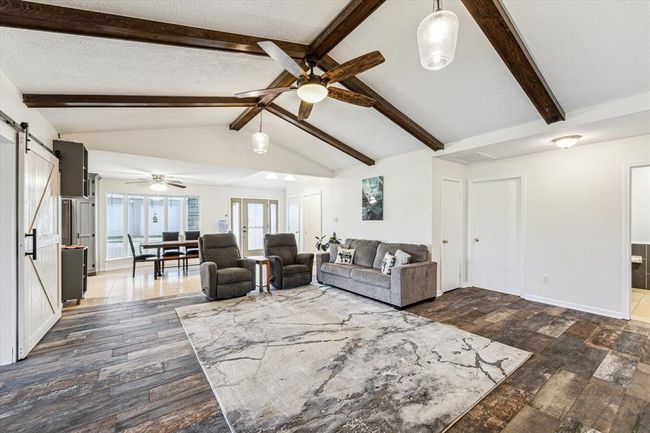 The choice of wood-like tile flooring adds a touch of warmth and natural charm to the room, providing the beauty of wood with the durability and easy maintenance of tile. It's a practical yet stylish flooring option that enhances the cozy ambiance of the space | Image 7
