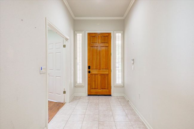 Foyer featuring crown molding and light tile patterned flooring | Image 4
