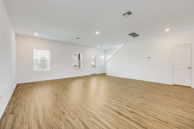 Unfurnished living room featuring light wood-style flooring and recessed lighting | Image 6