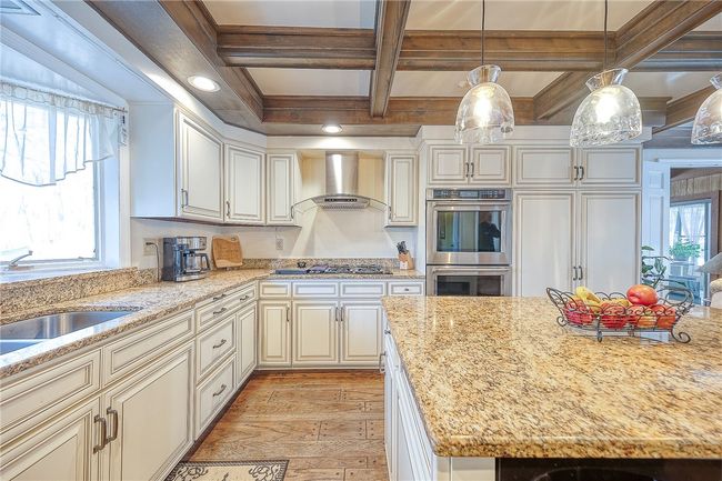 Updated kitchen features double ovens and a gas cooktop. | Image 5