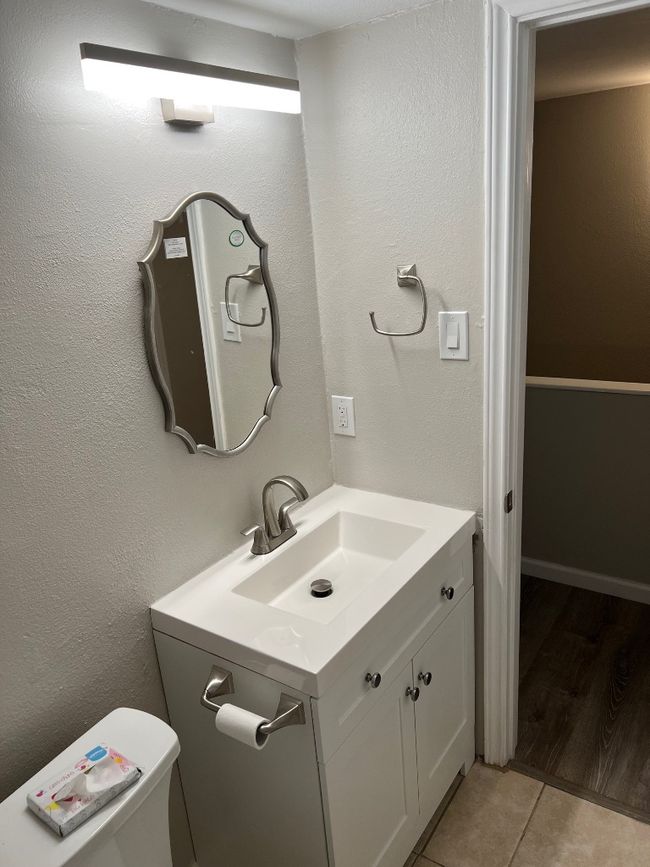 Half bathroom with toilet, vanity, and tile patterned flooring | Image 17