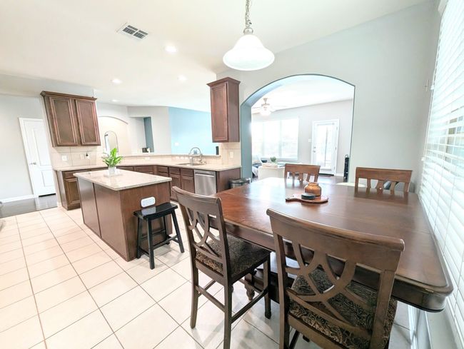 Dining room with arched walkways, light tile patterned flooring, and recessed lighting | Image 23