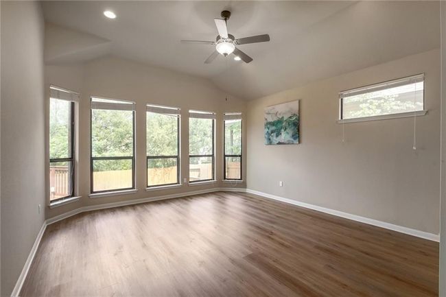 Spare room featuring vaulted ceiling, a ceiling fan, dark wood finished floors, and recessed lighting | Image 15