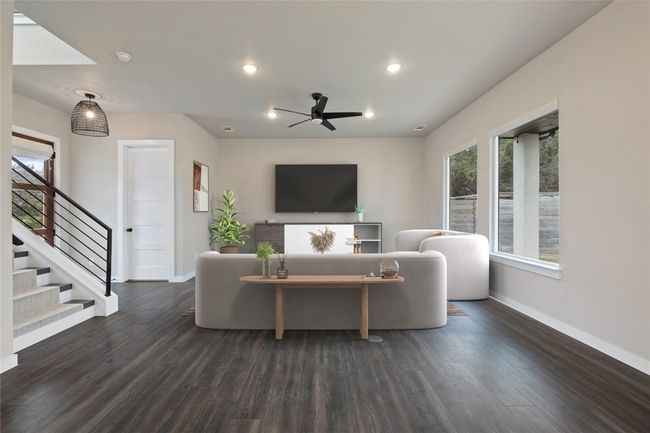 Living room with baseboards, stairs, ceiling fan, wood finished floors, and recessed lighting | Image 17