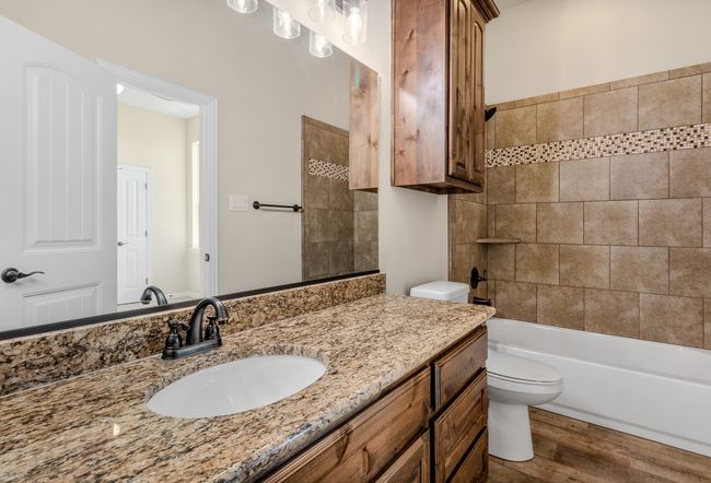 Full bathroom with toilet, vanity, wood finished floors, and shower / tub combination | Image 33