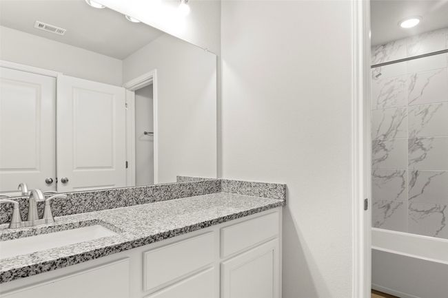 Bathroom with vanity and bathtub / shower combination | Image 26