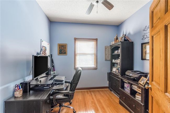 Office space with ceiling fan, light wood-style flooring, and a textured ceiling | Image 31
