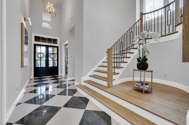 Entryway featuring a high ceiling, stairway, and a chandelier | Image 9
