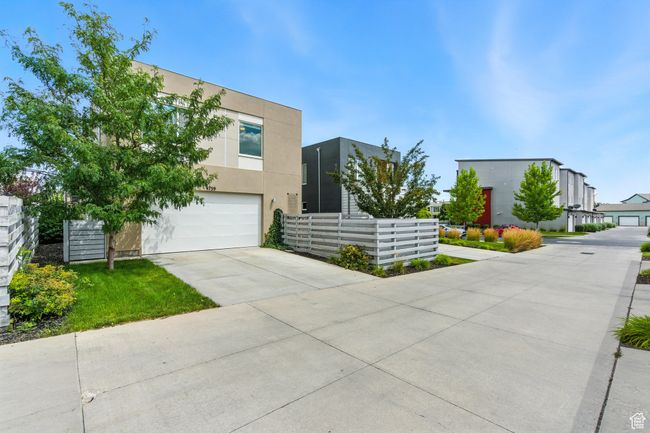 Modern home featuring driveway, stucco siding, and a garage | Image 4