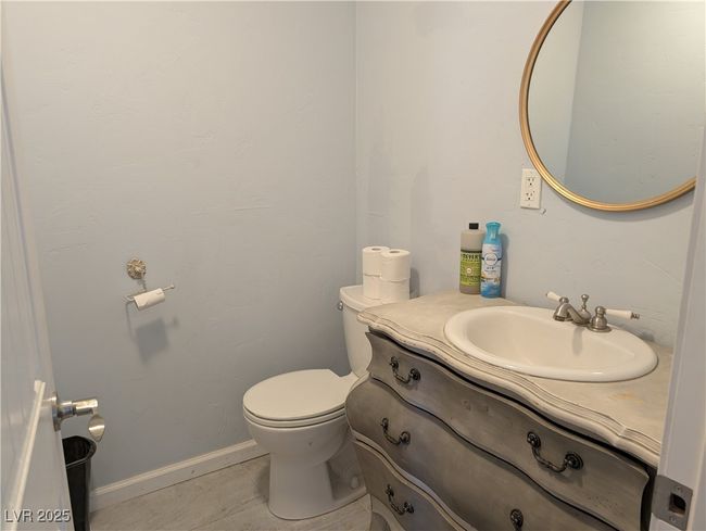 Half bath with baseboards, vanity, toilet, and tile patterned floors | Image 16