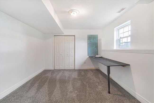 Unfurnished office with carpet floors, baseboards, and visible vents | Image 43
