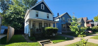 View of front facade with covered porch and a front lawn | Image 1