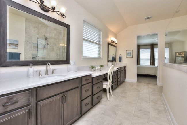 Ensuite bathroom with a tile shower, a healthy amount of sunlight, visible vents, and ensuite bathroom | Image 25