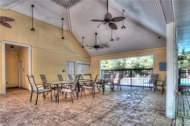 View of patio with ceiling fan and a fenced in pool | Image 17