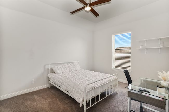 Carpeted bedroom with baseboards and a ceiling fan | Image 32
