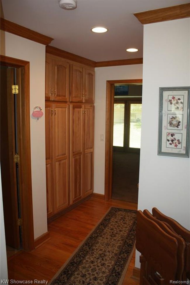 Hallway into first floor master bedroom, with lots of hallway storage, and a workstation on the opposite wall. | Image 22