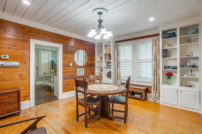 Dining room featuring a chandelier, ornamental molding, wood walls, light wood-style floors, and wood ceiling | Image 19