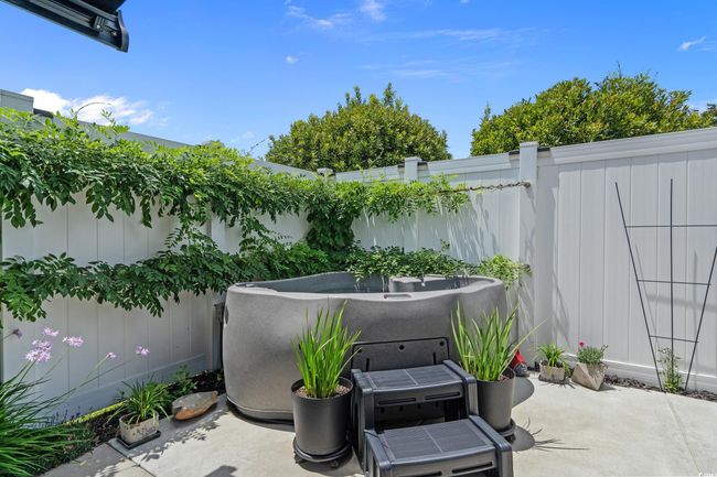 Fenced backyard with a patio | Image 32