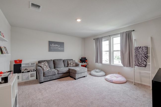 Living area with recessed lighting, light colored carpet, and visible vents | Image 21