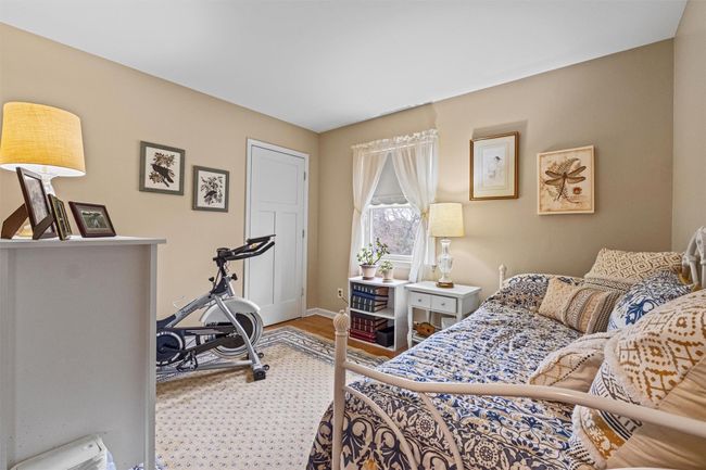Bedroom with wood finished floors and baseboards | Image 16