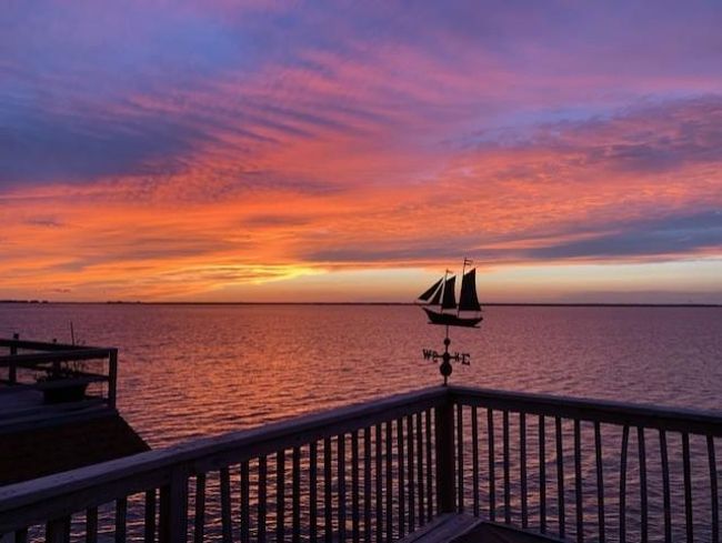 The spacious waterfront deck offers a private backdrop of sunsets that you'll look forward to every evening. | Image 47