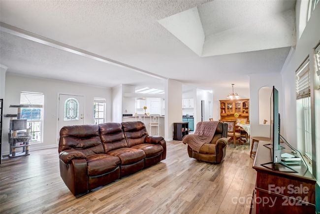 This home's open floor plan enhances the spacious feel - getting from the living area to the dining area is a breeze! | Image 9