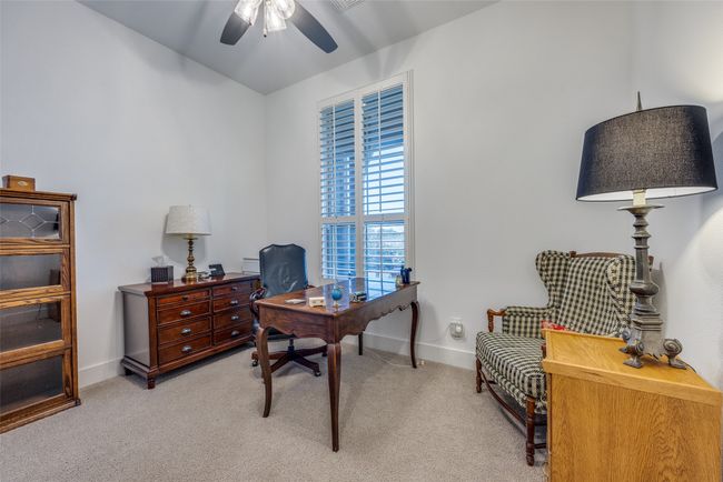 Office area featuring light carpet, baseboards, and a ceiling fan | Image 17