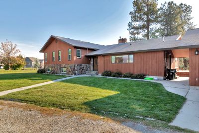 View of front of home featuring a front lawn and a carport | Image 2