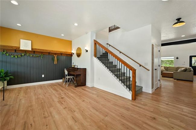 Welcome in! Warm and inviting and so much open space. Use the room for a playroom, you can have another formal dining or like pictured a space for your piano which is hard to come by in new construction. | Image 9