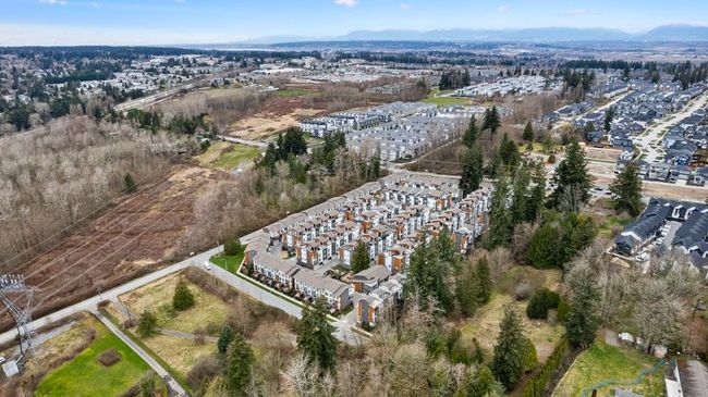 Aerial view of property's location with a mountainous background and nearby suburban area | Image 13