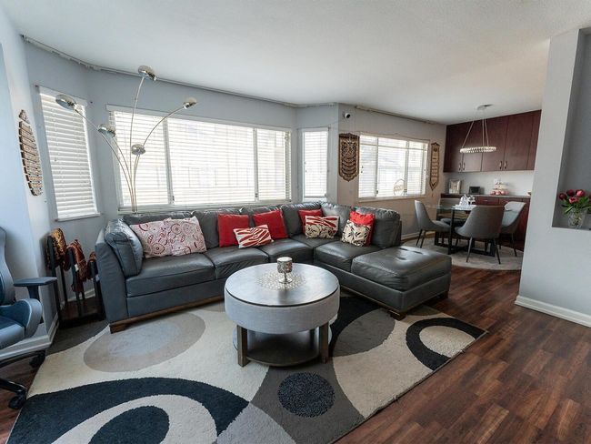 Living area with baseboards and wood finished floors | Image 14