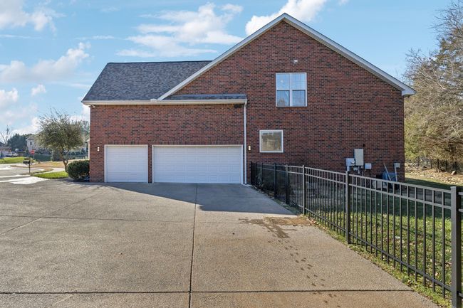 The three car side entry garage with extra driveway parking space makes having a houseful of drivers not so difficult. | Image 41