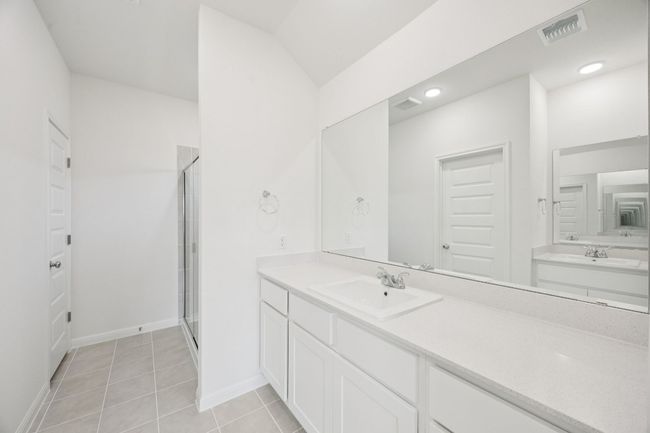 Full bathroom with a stall shower, vanity, and tile patterned flooring | Image 24